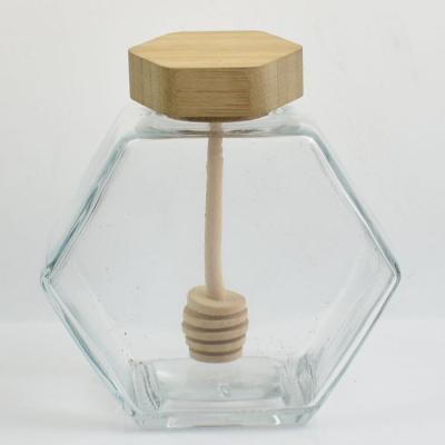 China Home Cheap Delicate Appearance Glass Honey Jars With Wooden Plunger for sale