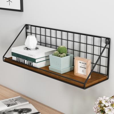 China Durable Creative Nordic Bedroom Shelf Living Room Wall Perforated Shelf for sale