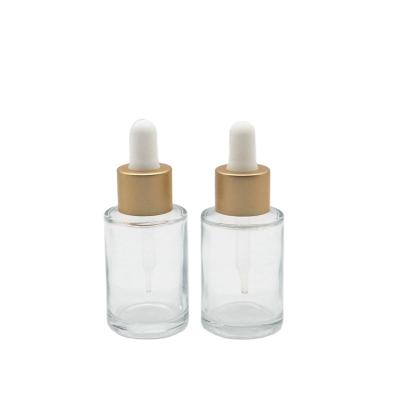 China Personal care 30ml round clear glass cosmetic bottle with 20mm gold silver dropper for sale