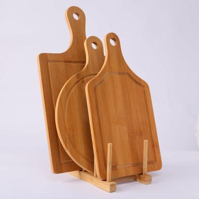 China Sustainable Wholesale Customized Eco-friendly Bamboo Cutting Board With Handle And Hole Pizza Board for sale