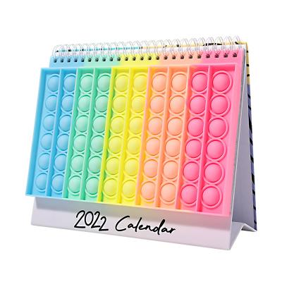 China 2022 Stress Worry Relief Toy Amazon Hot Sale Pop Push Bubble Decor Desk Calendar Busy Person Silicone Cover Table Calendar for sale