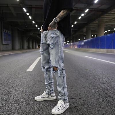 China Breathable European and American High Street Heavy Wash Water Whitening Ins Jeans Beard Big Cat Holes Fashionable Men's Pants Street Rap for sale