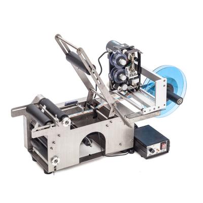 China Handheld manual food round bottle labeling machine with printing code, manual bottle labeler for sale