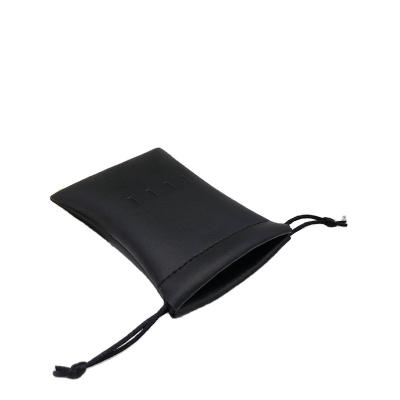 China Natural Luxury Black Leather Drawstring Cosmetic Pouch Round Bottom Gift Bags Dust Leather Cut Out Perfume Jewelry Bag for sale