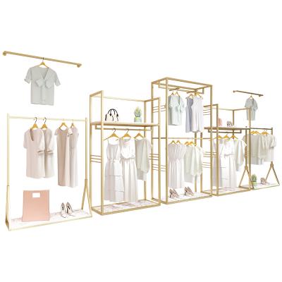 China Clothes shop custom clothing store wall mount garment clothes stand metal fabric display stainless steel shiny gold clothing rack for store for sale