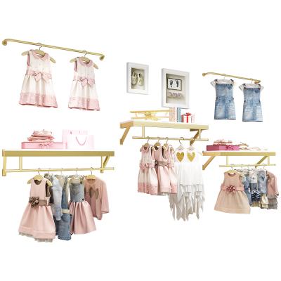 China Clothes Shop Shiny Gold Kids Stainless Steel Clothing Rack Wall Mounted Metal Clothes Stand Boutique Cloth Store Shelves Display for sale