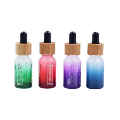 China Cosmetics Essential Oil Packaging 10ml 15ml 20ml 30ml 50ml Round Shoulder Gradient Colored Glass Bottle With Bamboo Serum Dropper for sale