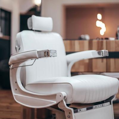 China Tarka White Leather Extended Barber Chair Vintage Hot Sale Barber Chair Design Traditional Elegant Classic Salon Furniture for sale