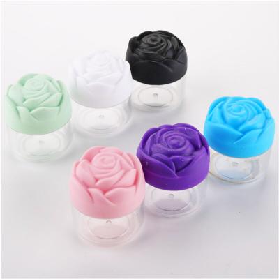 China Unique Shape 20g Cosmetic Gel Polish Jars Clear Plastic Nail Cylinder Powder Jar With Flower Shaped Cap for sale