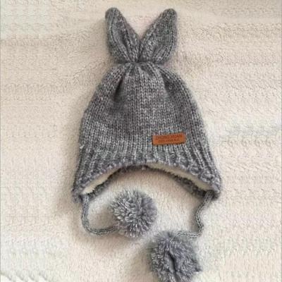 China 2020 New JOINT Rabbit Ear Winter Children Knit Earflap Hat Earmuffs Hat With Pompoms for sale