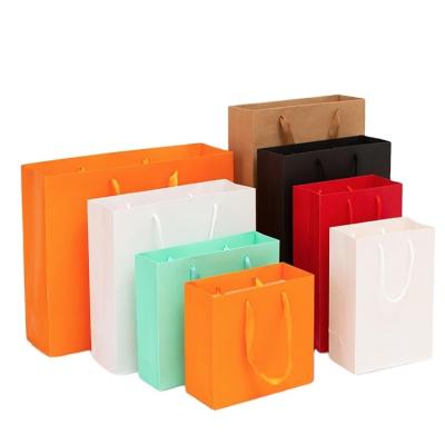 China Recyclable Custom Craft Gift Cardboard Packaging Shopping Paper Bag With Handles Kraft Paper Bag With Logo for sale