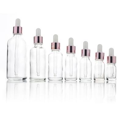 China 5ml 10ml 15ml 20ml 30ml 50ml 100ml Skin Care Oil Glass Bottle Essential Oil Dropper Clear Round Glass Bottles with Rose Gold Dropper Cap for sale