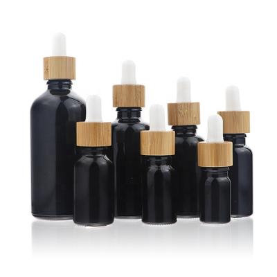 China Non Spill Empty Essential Oil Matte Black Frosted Glass Dropper Bottle 5ml 10ml 15ml 20ml 30ml 50ml 60ml 100ml 200ml With Bamboo Lid for sale