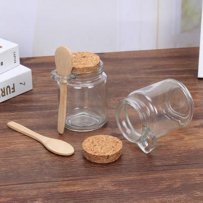 China Heatable Kitchen Container 8oz Spice Bath Salt Glass Seasoning Jars Honey Jar With Wooden Lid And Spoon for sale