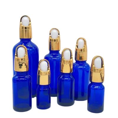 China Personal Care 10ml 15ml 20ml 30ml 50ml 100ml Personal Care Essential Oil Bottle Glass Dropper Bottle Blue With Gold Cap for sale