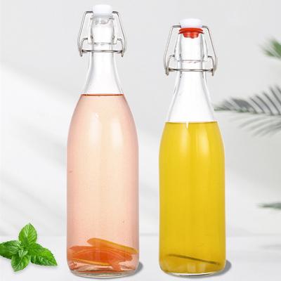 China Clear Beverage Bordeaux 500ml Flat Bottom Swing Top Lid Beverage Beer Glass Wine Bottle With Caps for sale