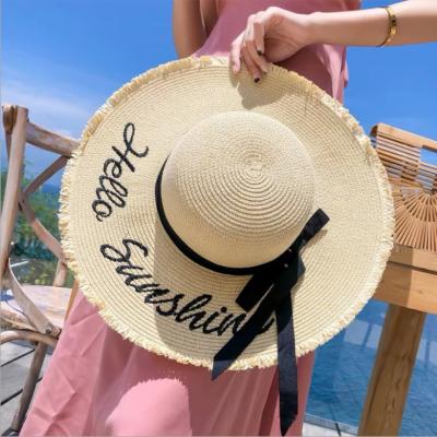 China Foldable Rolled Black Ribbon Lace Up Big Brim Straw Hat Outdoor Beach Hat Summer Covers Handmade Weave Letter Sun Hats For Women for sale