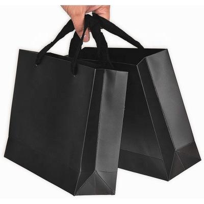 China Recycled Materials Recyclable Rectangular Bottom Ribbon Handles Shopping Packaging Craft Black Paper Gift Bags For Clothes Gift for sale