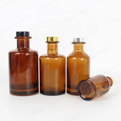 China Home Decoration Luxury Amber Glass Diffuser Bottle Round Shaped Glossy Amber Glass Reed Diffuser Glass Bottle for sale