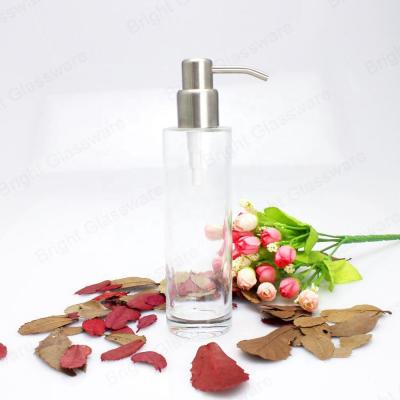 China Gift Bathroom Personal Care Essential Oil Lotion Glass Clear Bottle With Stainless Steel Pump Cap for sale