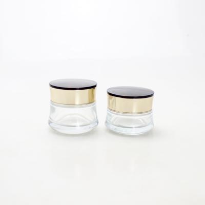 China Luxury clear cosmetic skin care cream glass jar with gold screw cap for sale