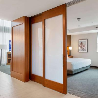 China Modern Marriott Hotel Style Ceiling Mount Bypass Sliding Wood Barn Door With Track System for sale