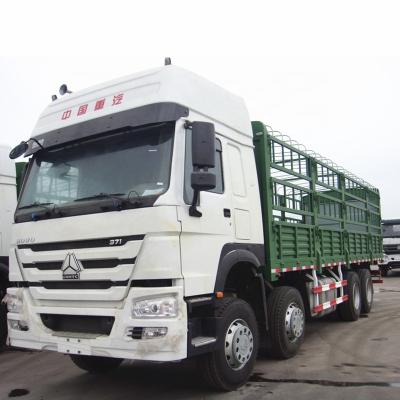 China SINOTRUK HOWO 8X4 371HP 35T CARGO TRUCK WITH SIDEWALL AND BARRIER GREEN COLOR ZZ1317N4667V 12000*2500*3850 for sale