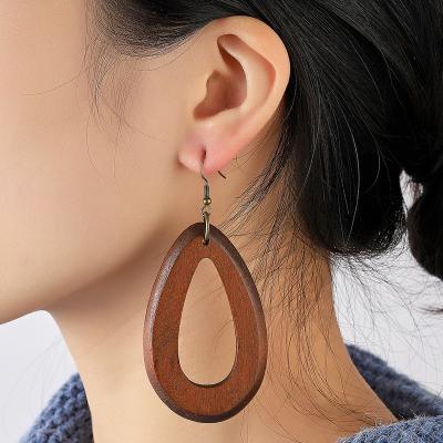 China FASHIONABLE Women's Brown Hollow Wooden Earrings Hollow Out Large Fashion Round Pendants Shape Drop Earrings for sale