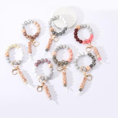 China New Quality Promotional Gift Silicone Letter Bracelet Elastic Wood Bead Bracelet Key Chain For Women for sale