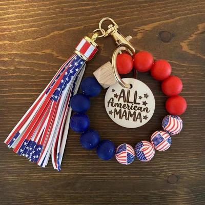 China Wholesale Creative MOM Party Gift/Silicone Bead Bangle Bracelet Key Chain Engraved Disc with Tassel Keychain for Mother's Day Gift for sale