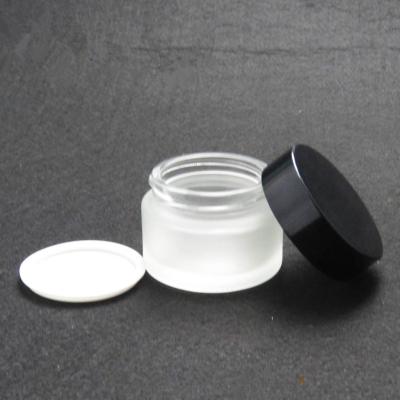 China Wholesale Round Glass Bottle 20g 30g 50g Matte Glass Bottle Clear Matte Glass Jar Jar With Black Aluminum Cap for sale