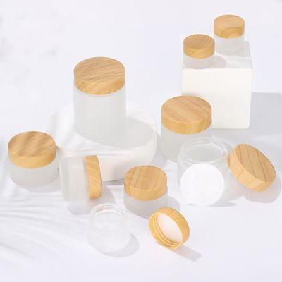 China Luxury personal care 15g 30g 50g 100g bamboo cover frosted glass jar cream bottle contains bamboo cream jar for sale