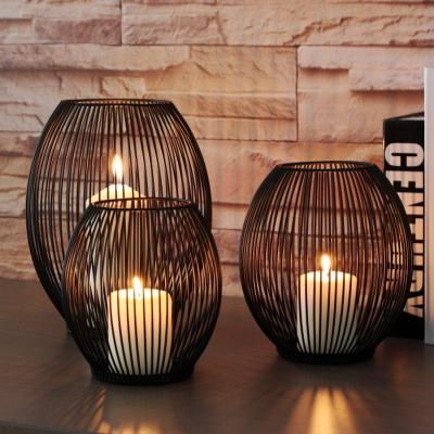 China Cheap home decorative black cage wedding metal candle holders pillar decoration simple ironline candle holder for sale