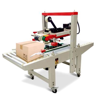 China Full Automatic Manual Food Flaps Fold Up And Down Drive Belt Adhesive Tape Box Carton Sealing Machine for sale