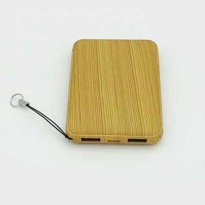 China Mobile Phone Mini Wood Grain 5000mAh Power Bank Pocket Dual USB Power Bank for sale