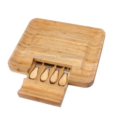 China Viable High Quality Bamboo Cheese Cutting Board with 4 Knives Tool Kit Wholesale Bamboo Cutting Boards for sale