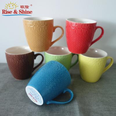 China Sustainable Wholesale Ceramic Coffee Mugs Green Color Red Blue Mug Embossed Ceramic Mug Small Size for sale