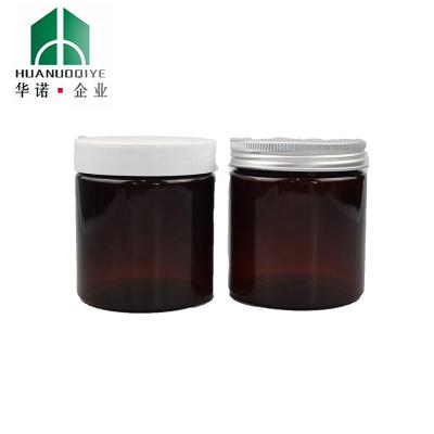 China Food Jar 2 Ounce THC Hemp Amber Color Child Resistant Plastic Jar With Black Lids for sale