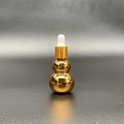 China 50ml 100ml Gourd Glass Bottle Face Serum Essential Oil Bottle Cosmetic Luxury Gold Bottle for sale