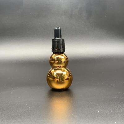 China Cosmetic Custom Gold Gourd Shape Essential Oil Glass Bottle Dropper Electroplating Glass Bottle for sale