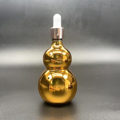 China Cosmetic Empty Gourd Shape Essential Oil Dropper Bottle Face Care Bottle Electroplate Gold Glass Bottle for sale