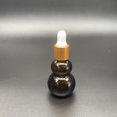 China Amber Cosmetic Packaging Bottle Essential Oil Glass Bottle Double Squash Empty Aroma Bottles for sale