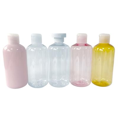 China Cosmetic Refillable Shampoo Body Lotion 300ml 250ml Round Plastic Shampoo Bottles With Flip Top Cap for sale