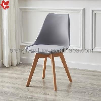 China 2022 Design Furniture Polypropylene PP Plastic Chair New Chair Tulip Dining Plastic Chairs For Living Room White Color Wooden Legs Wholesale for sale