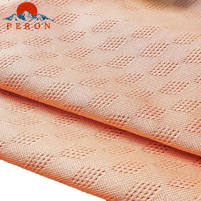 China Custom Stretch Orange Color Solid 75D Polyester Plain Knitted Fabric For Sportswear for sale