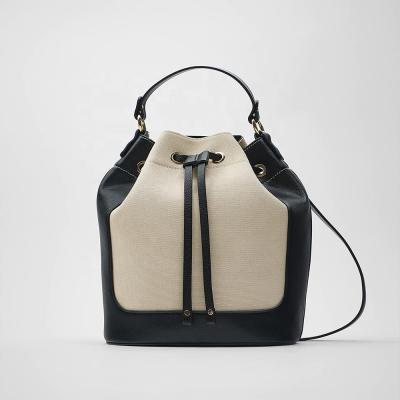 China SS22 Fashion Drawstring Beach Cotton Canvas Pebble Trim Leather Barrel Cross - Body Bucket Bag for sale