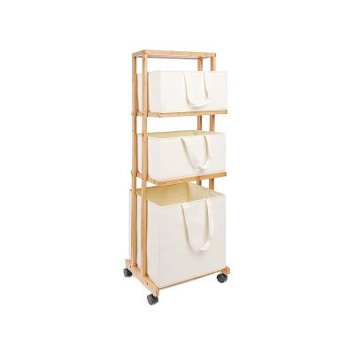 China 3 Tier Modern Wholesale Rolling Bamboo Laundry Hamper Canvas Laundry Basket Wheels With Storage Bag for sale