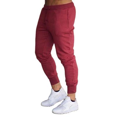 China Anti-wrinkle Men's Outdoor Sports Pants Solid Color Drawstring Casual Open Bag Design Feet Slim Pants Jogging Sports Fitness Pants for sale