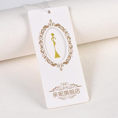 China Sustainable Manufacturing Hang Tags Embossed White Kraft Custom Made Hang Tag For Clothes From Factory for sale