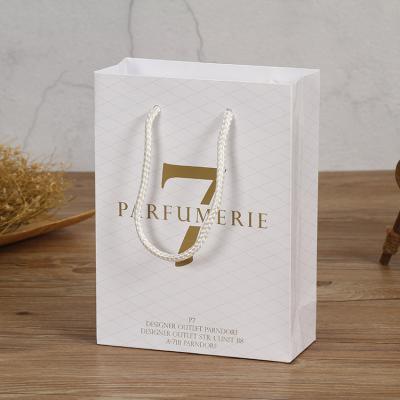 China Hot Sale Fashion Biodegradable Logo Name Paper Packaging Bag Custom Clothes Shopping Bags With Handle for sale